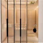 Thumbnail of http://Bathroom%20with%20black%20toilet,%20wall%20niche,%20marble%20tiles%20and%20wood%20cabinetry.