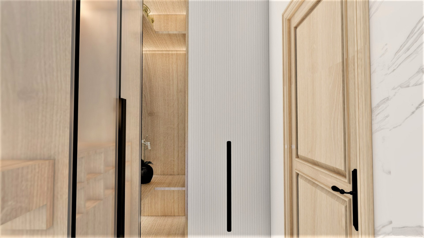 Walk-in shower with glass screen, black shower fittings and marble wall.