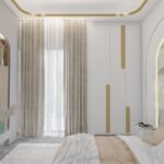 Thumbnail of http://Bedroom%20wall%20with%20black-and-white%20framed%20artwork%20beside%20a%20neutral%20upholstered%20bed%20and%20illuminated%20headboard.