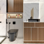 Thumbnail of http://Shower%20area%20with%20black%20fixtures,%20wood%20accent%20niche%20and%20marble%20tiles.