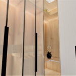 Thumbnail of http://Bathroom%20vanity%20with%20wood%20slats,%20marble%20splashback%20and%20countertop%20basin.