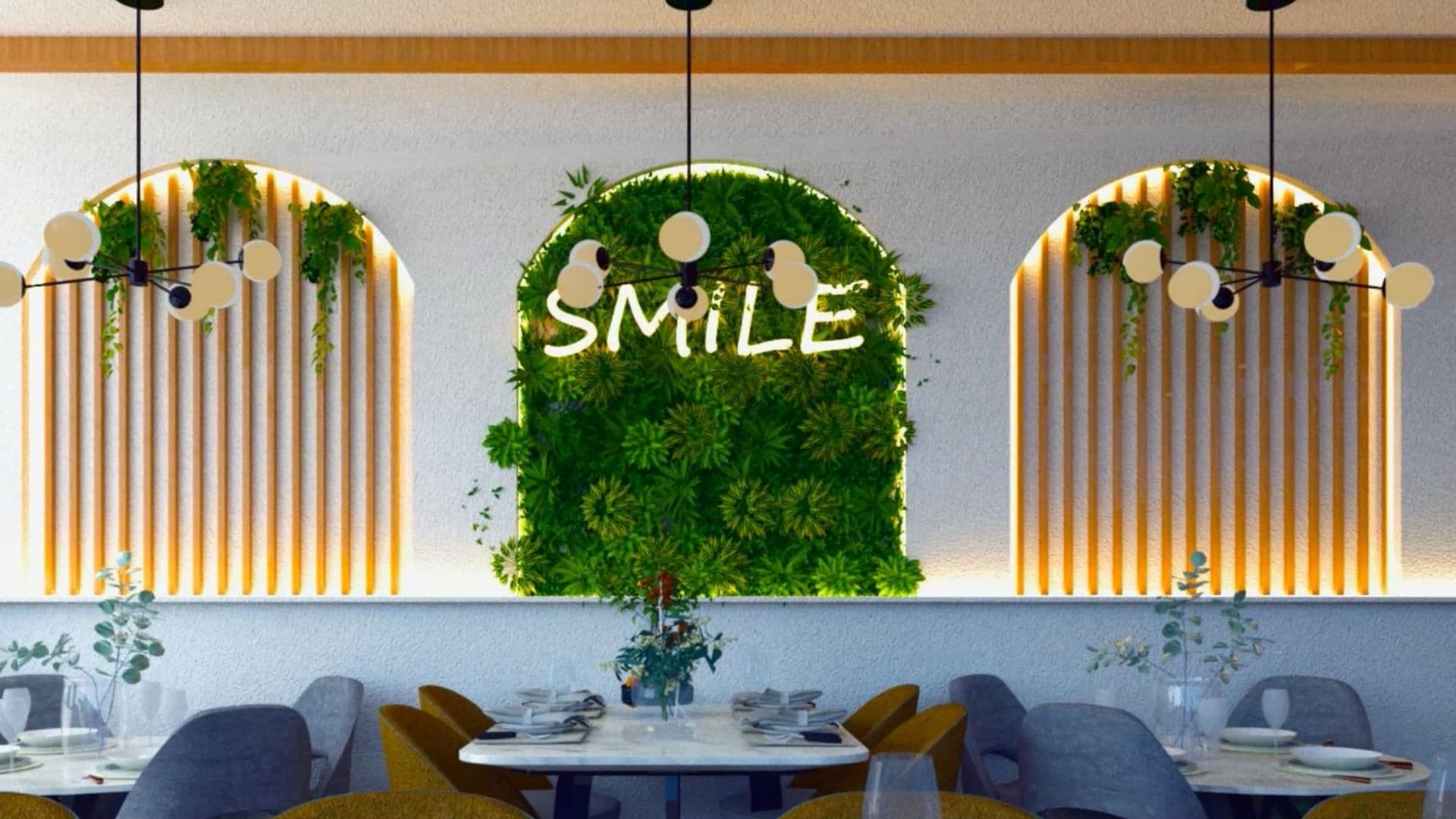Modern Greenleaf Cafe in Notting Hill interior wall feature with “Smile” neon sign and green foliage.