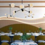 Thumbnail of http://Modern%20Greenleaf%20Cafe%20in%20Notting%20Hill%20dining%20room%20with%20banquette%20seating%20and%20wall%20panelling.​
