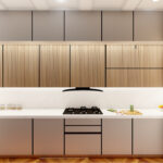 Thumbnail of http://Refined%20modern%20kitchen%20installation%20displaying%20grey%20flat-panel%20handleless%20lower%20units,%20pristine%20white%20marble%20working%20surfaces%20and%20protective%20backsplash,%20backlit%20natural%20wooden%20vertical%20slat%20upper%20cabinets%20with%20integrated%20LED%20illumination,%20geometric%20herringbone%20wood%20floor%20pattern,%20seamlessly%20integrated%20modern%20gas%20cooktop%20and%20built-in%20oven,%20stainless%20refrigerator,%20contemporary%20sink%20with%20matte%20black%20tap,%20minimalist%20design%20aesthetic,%20warm%20neutral%20tones,%20and%20functional%20elegant%20cooking%20area%20in%20Reigate%20residence.