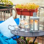 Thumbnail of http://Cosy%20boho%20balcony%20setup%20with%20rattan%20chair,%20blue%20textiles,%20lantern,%20and%20planter%20rail.
