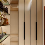 Thumbnail of http://Walk-in%20wardrobe%20with%20illuminated%20glass%20shelves,%20handleless%20cabinets,%20display%20storage%20and%20pendant%20lighting