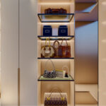Thumbnail of http://Elegant%20walk-in%20closet%20entrance%20with%20handleless%20white%20cabinets,%20pendant%20lights,%20open%20shelving%20and%20luxury%20storage%20design
