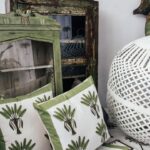 Thumbnail of http://Boho%20balcony%20styling%20vignette%20with%20palm-print%20cushions,%20rustic%20cabinets,%20and%20white%20woven%20lantern.
