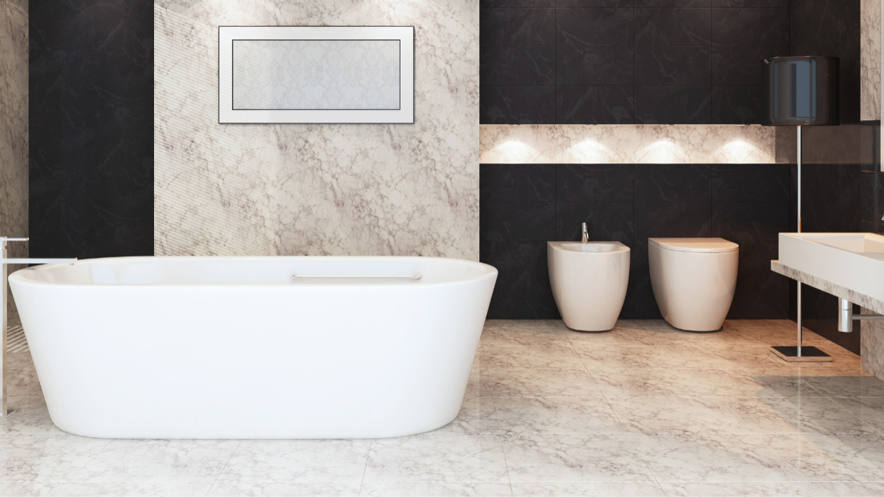 Refined whole-home renovation featuring quality marble and stone finishes on surfaces and floors, curated modern furniture pieces with contemporary styling, harmonious neutral tones with sophisticated palette, skilled execution in all installations, practical elegant spaces throughout residence, complete lighting service with ambient and accent fixtures, sculptural white bathtub in designer bathroom, warm wood wall treatments with natural grain, generous windows with natural daylight, custom built-in storage throughout, premium fixtures and fittings, serene bedroom with upholstered furniture and mood lighting, open flowing floor plan with connected areas, gold and bronze metallic touches, botanical plants and green accents, sleek contemporary furniture selections, unified material story across home, functional home office solutions, and complete design service from concept to completion in Kensington