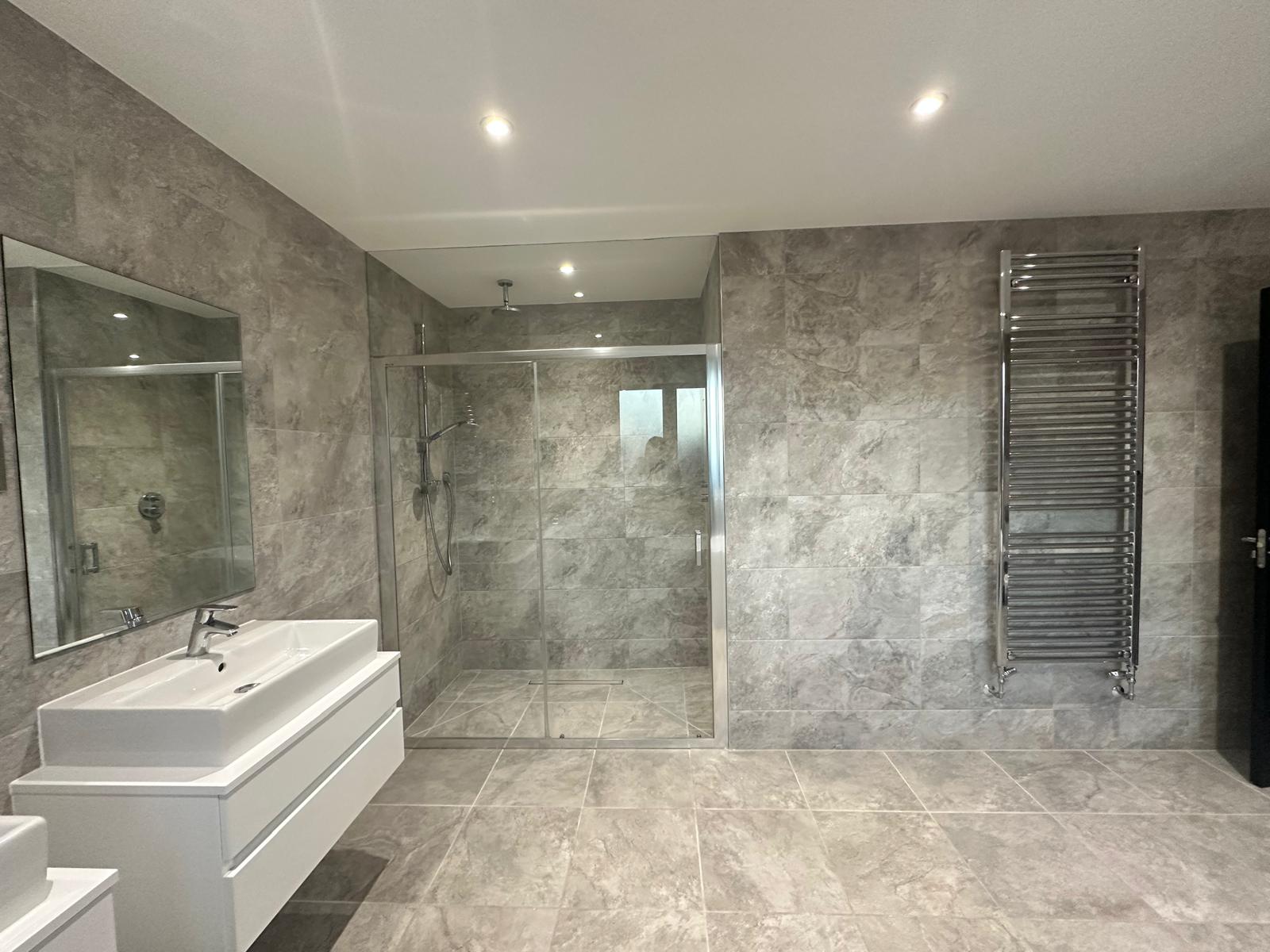 Modern luxury bathroom renovation in Knightsbridge with stone-effect tiles and spa-inspired design